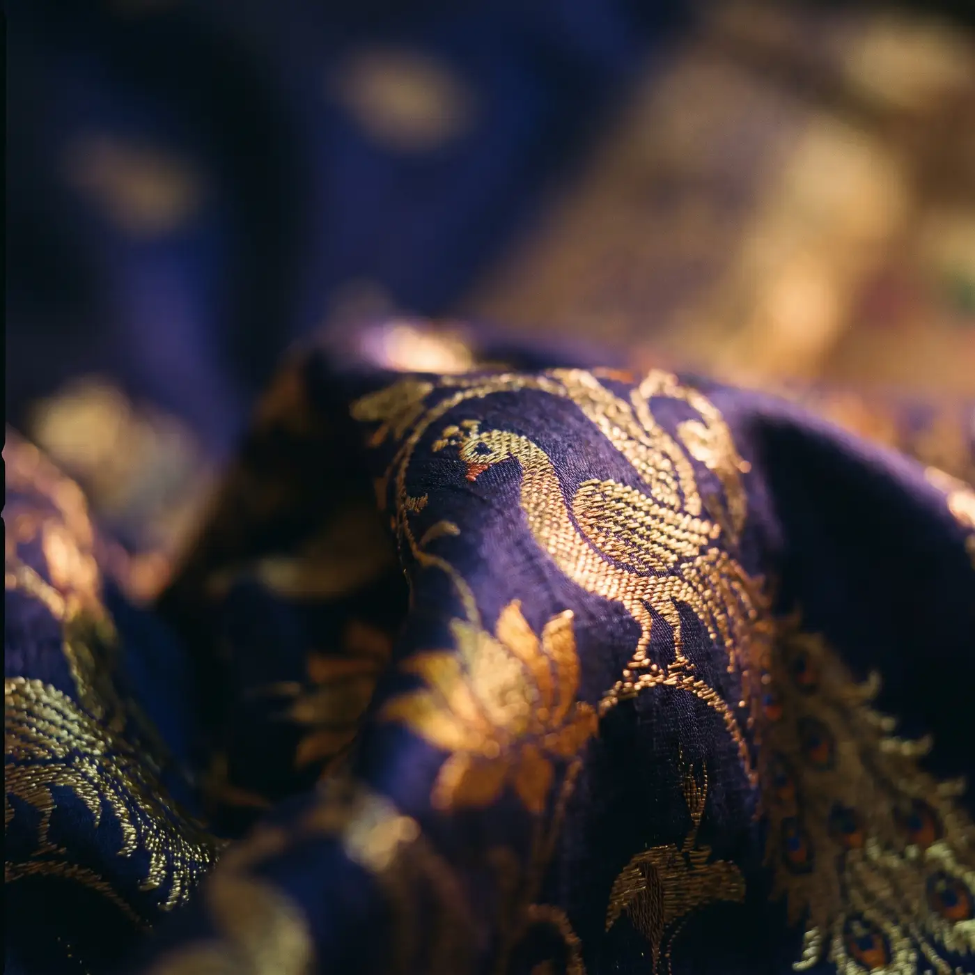 Macro of an indigo and gold Paithani silk weave